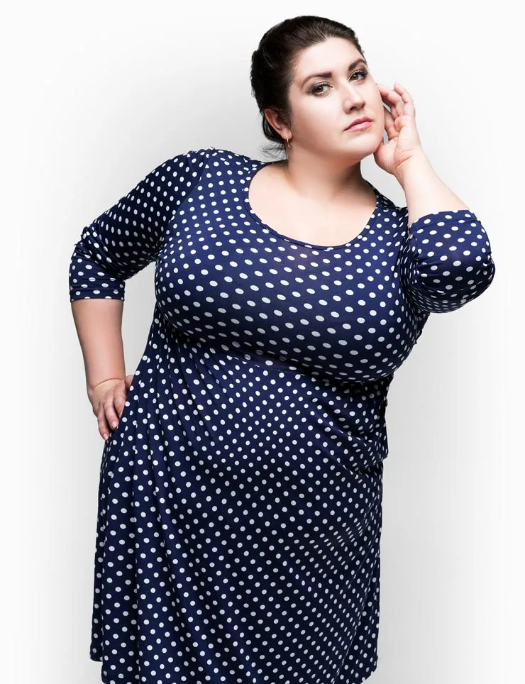 Female model in blue and white polka-dot dress