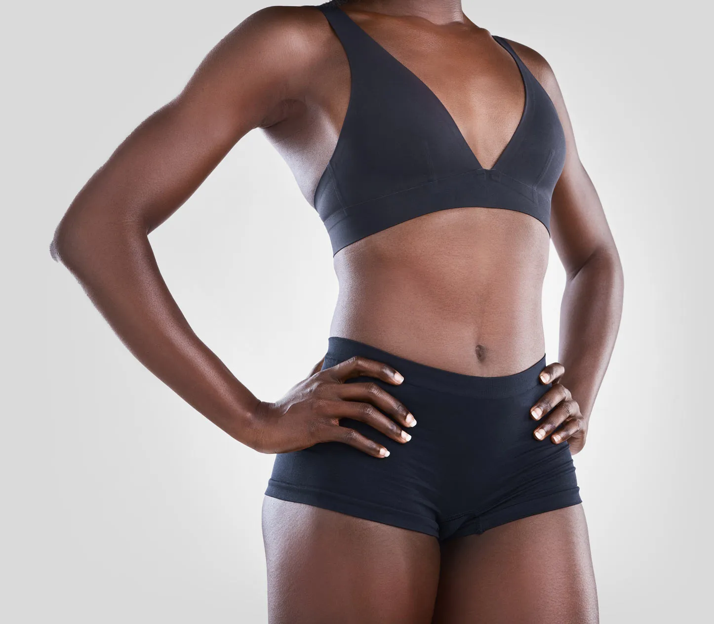 Person wearing black athletic wear, hands on hips