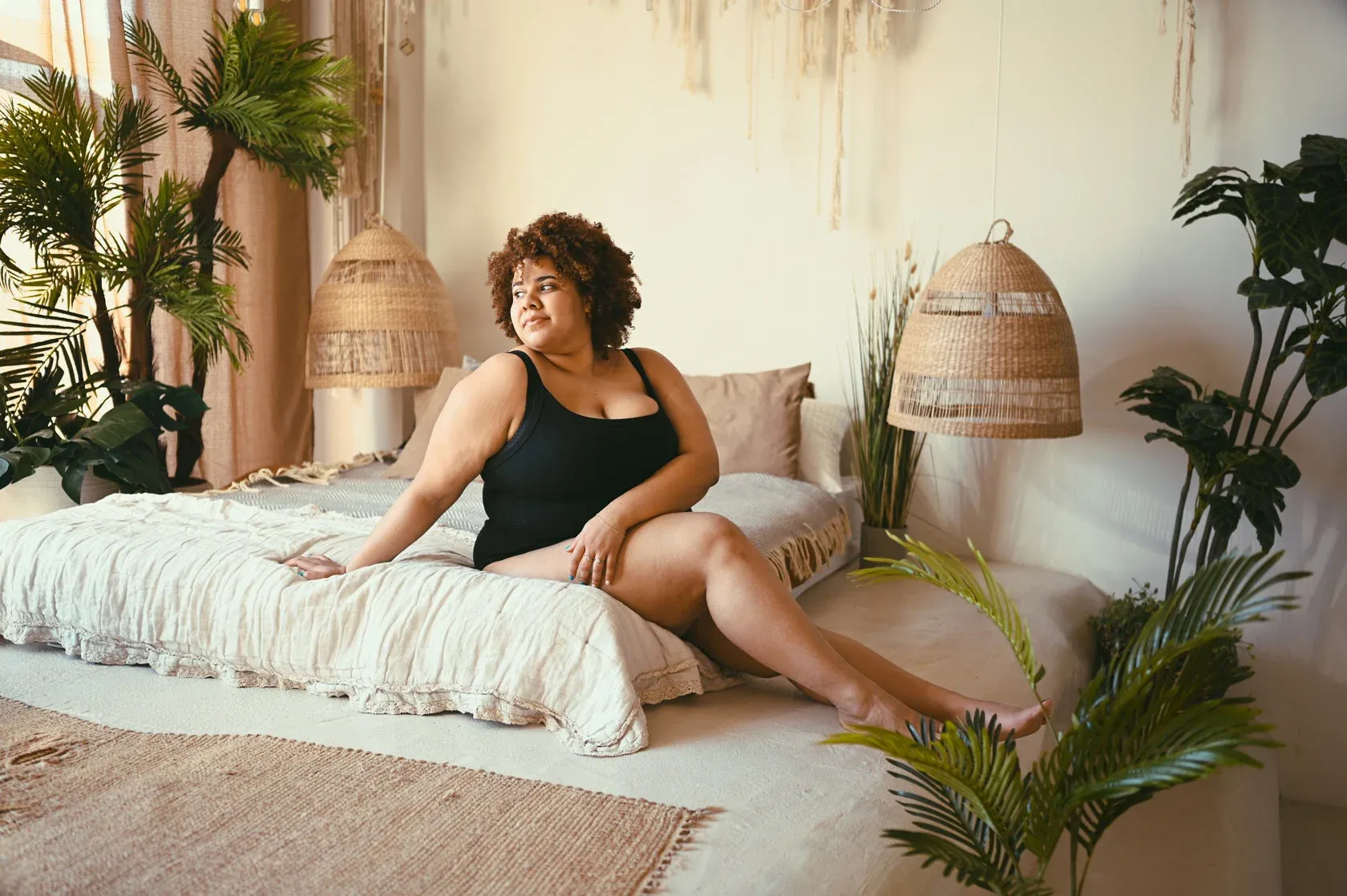 Woman relaxing on bed in cozy room.