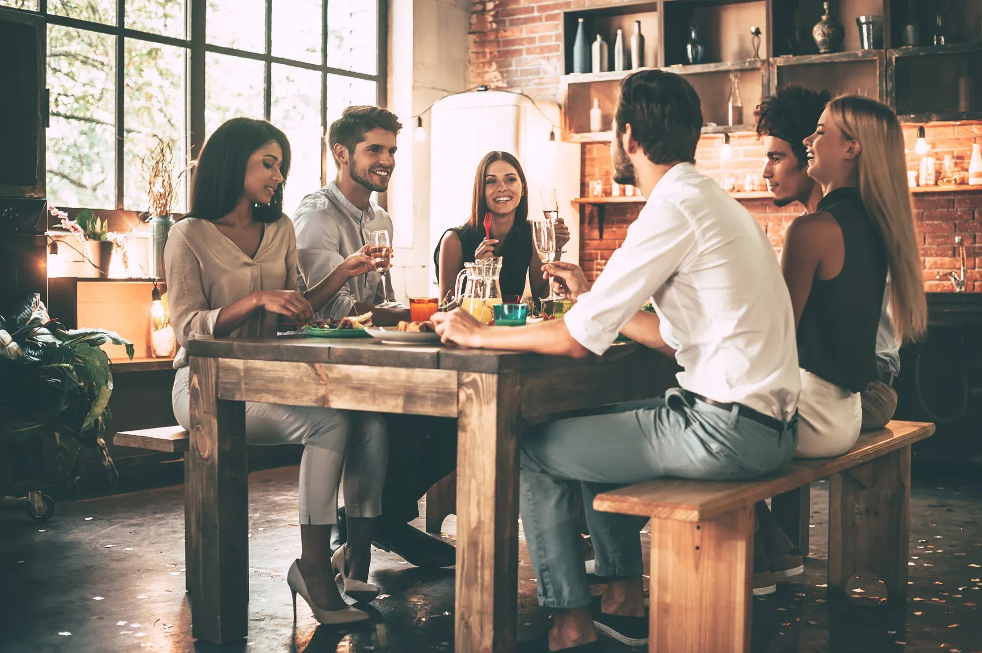 Friends dining and chatting together indoors