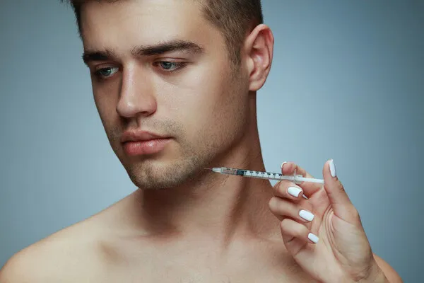 A young man choosing the non-surgical jawline contouring treatment