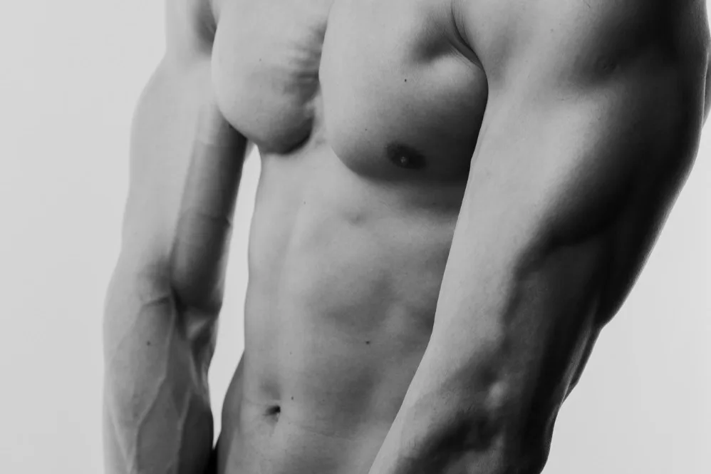 Close-up shot of a masculine and athletic body after getting plastic surgery