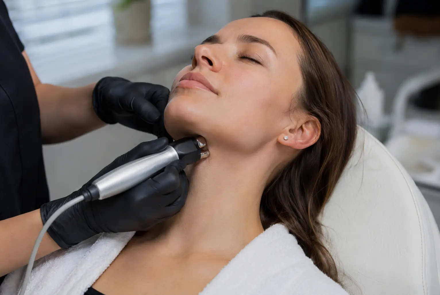 Patient receiving FaceTite skin tightening on the lower face and neck