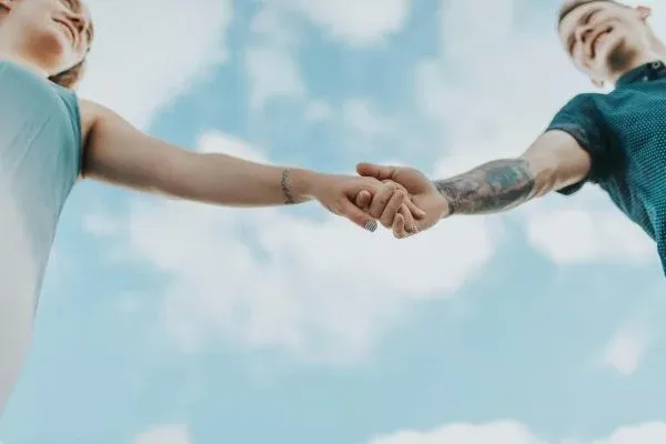 3 A couple holding each others hands