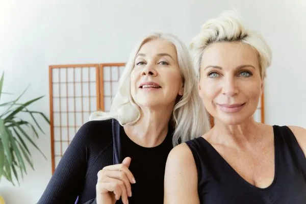 Two women are happy with plastic surgery results