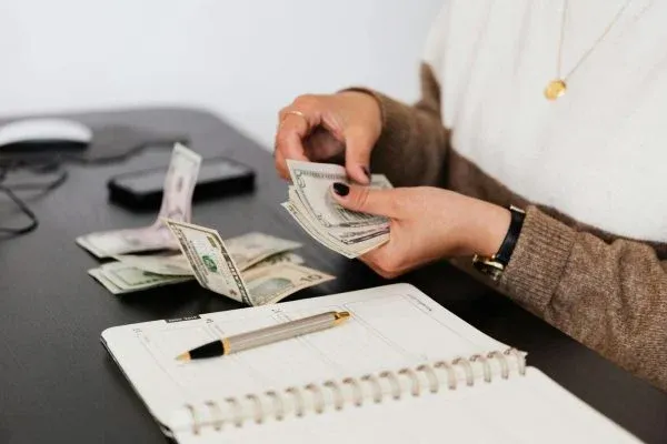 A person counting money for plastic surgery