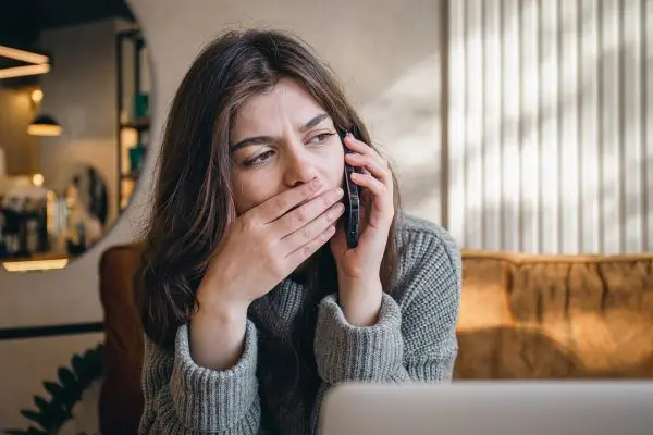 A worried woman calling someone on the phone.