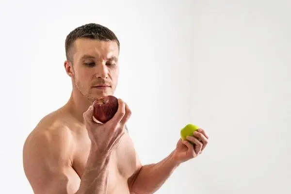 A fit man eating healthy fruits to maintain a healthy lifestyle