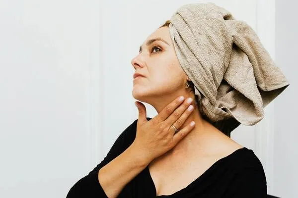 A woman applying silicone gel after plastic surgery