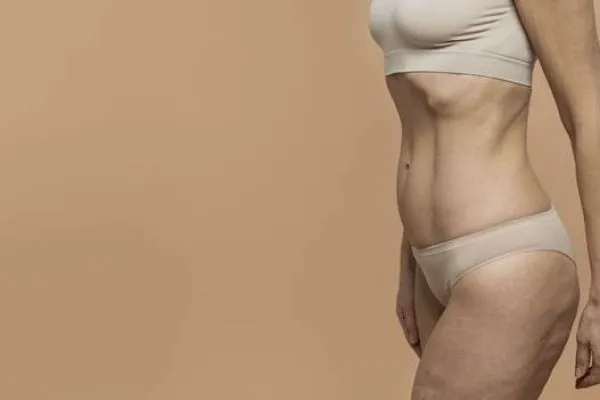 An adult woman in lingerie after a tummy tuck