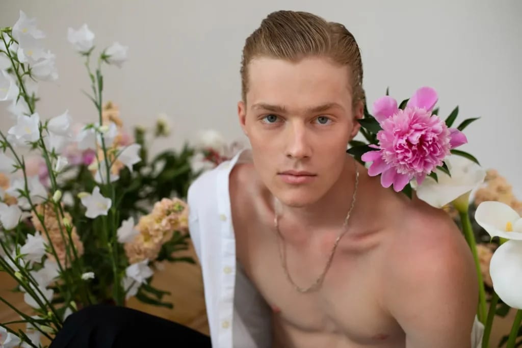 Sensitive man posing with flowers front view after plastic surgery