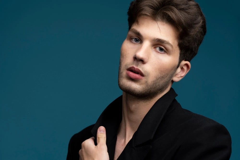 Medium shot man posing with blue background