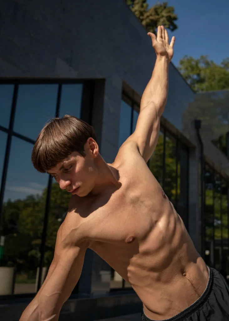 Shirtless man working out outside